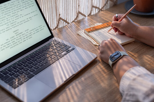 Writer taking notes while working