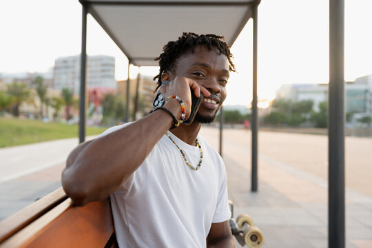 man enjoying phone call on urban bench