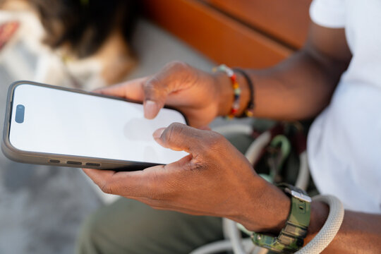 Close-up of hands using smartphone outdoors