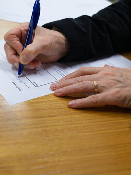 Handwriting on Form During Document Completion at Desk