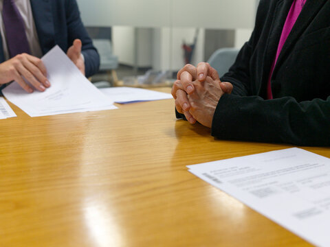 Business Meeting Discussing Important Documents at a Conference Table