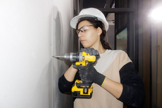 portrait of a young woman with a screwdriver in her hand