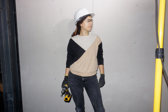portrait of a young woman with a screwdriver in her hand