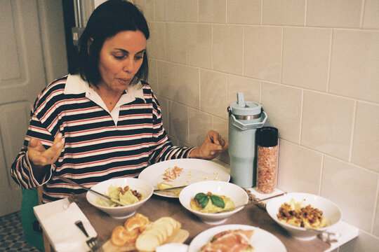 Woman Enjoying Variety Hummus Dishes