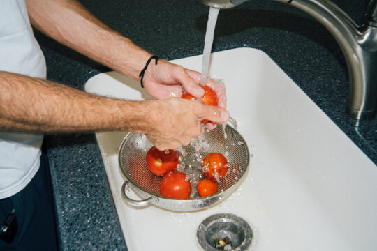 Washing Vegetables in Kitchen Sink