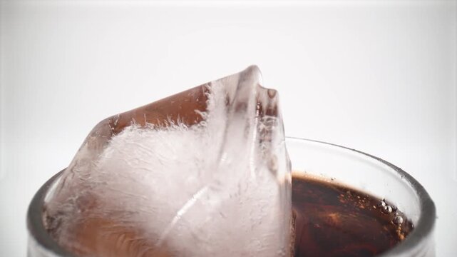 Close up view of cola in glass with ice isolated on white background