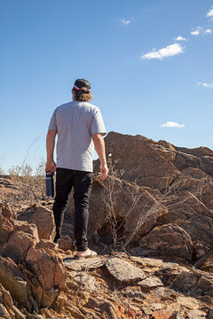 Man's back in outback Australia looking at the view. Travel concept.