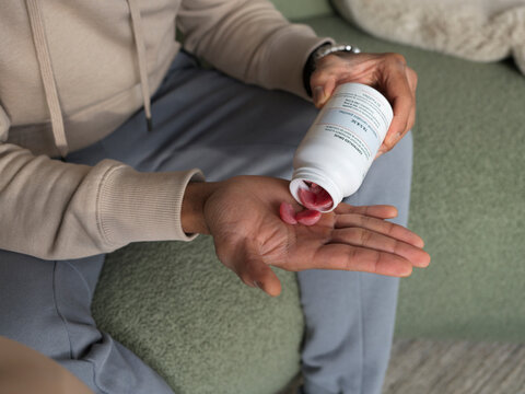 Person Takes Prescription Cannabis Gummies From Bottle