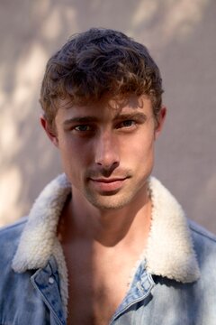 Young Man With Tousled Hair in Denim Jacket and Natural Light