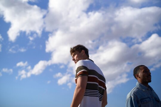 Friends Enjoying a Sunny Day Outdoors Under a Blue Sky