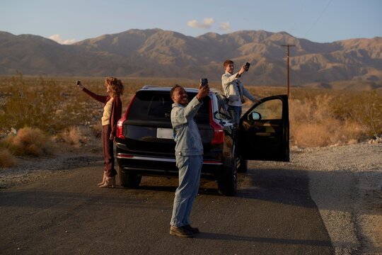 Friends Enjoy a Road Trip While Taking Selfies in the Desert