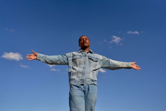Young man enjoying a clear blue sky outdoors