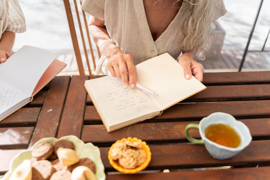 Hands writing in notebook