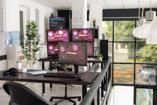Desktop monitors show system error warnings in empty office workspace. The scene represents software failure, technical issues and business interruption in modern IT environment.
