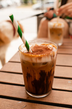 Iced Mocha Coffee with Green Paper Straw at Outdoor Caf&eacute;