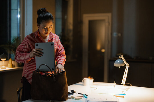 A woman finishes her night job at the office