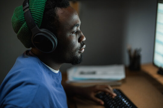 A man uses a computer at night