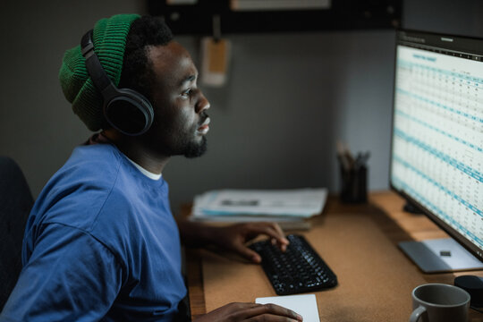 A man uses a computer at night