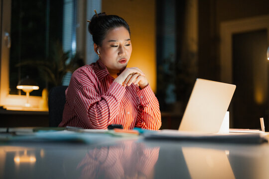 A woman is talking on a video chat at night
