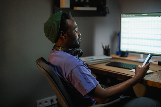 A man uses a mobile phone in the office at night