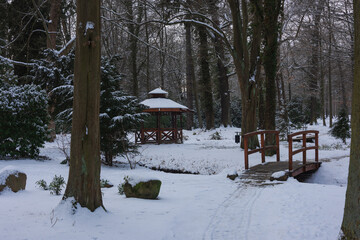 Pałac dworski w mieście Iłowa w zimowy dzień. Część japońska parku z elementami architektury parkowej w postaci lampionów, kładek, schodów, altanek, stawu parkowego i strumyka. © boguslavus