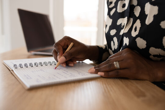 Woman calculating budget at home
