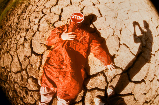 Conceptual portrait of a man holding a stop sign