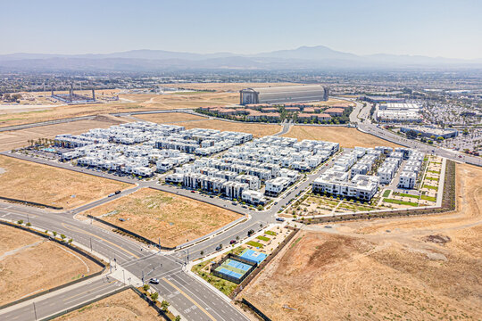 Tustin, California, Orange County - July 30, 2024: Aerial Drone Tustin Irvine View Photo toward Barranca Pkwy, Warner Ave, Red Hill Ave, Tustin Legacy Community with Apartment, House, Home, Town, Stre