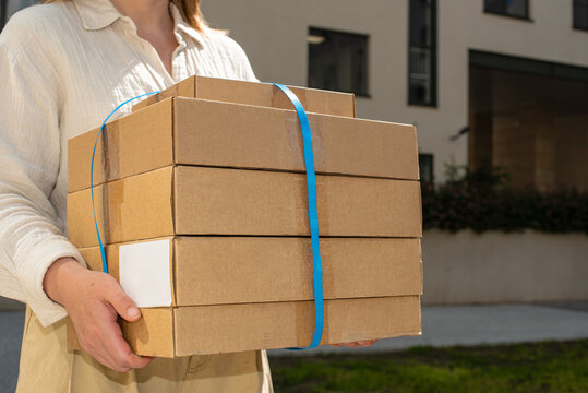 Delivery of multiple packages outside a modern building