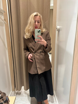 woman taking a selfie in a fitting room