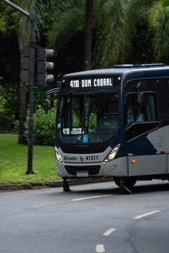 Blue and grey Marcopolo Torino bus front panning shot, Public transportation vehicle on city street