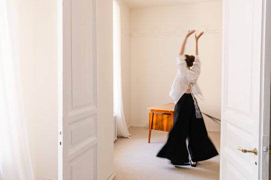Woman Dancing in Mid-Century Interior Joyful Moment