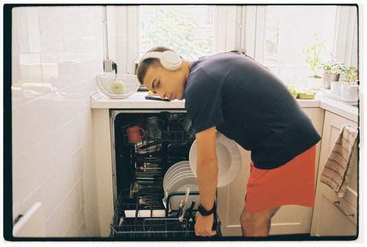 Teen Loading Clean Dishes