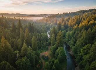 Serene forest landscape at sunrise with winding river and distant hills a solitary orange tent glows warmly on a faint path below