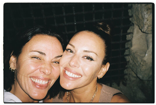 Close-Up of Two Women Smiling at Night