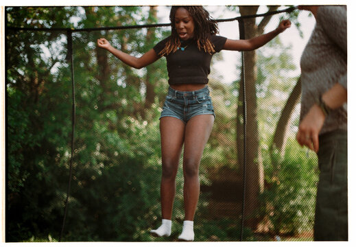 Girl jumping on trampoline