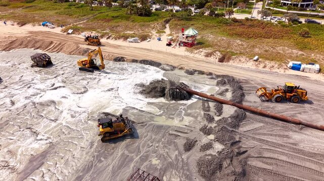 Excavators track loaders preading sand on Delray Beach renourishment 2026