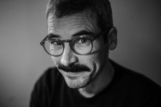 Warm Smirk and Eye Contact in Natural Light

