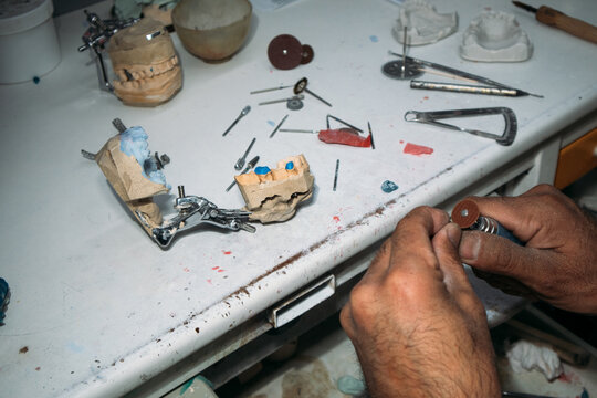 Dental technician working on model