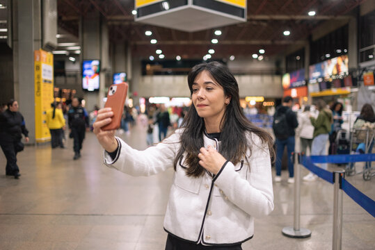 Woman at the airport using cell phone
