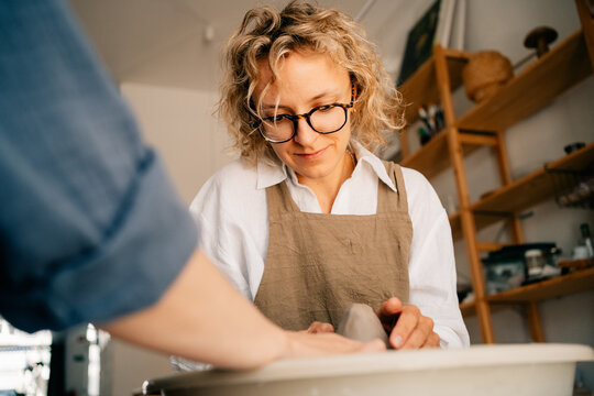 Pottery Artist Creating Vase in Studio During Sunny Afternoon