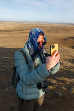 Taking a Selfie on a Windy Day at a Scenic Outdoor Location