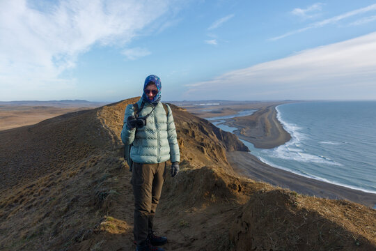 Hiking Along the Coastal Cliffs With a Camera at Sunset