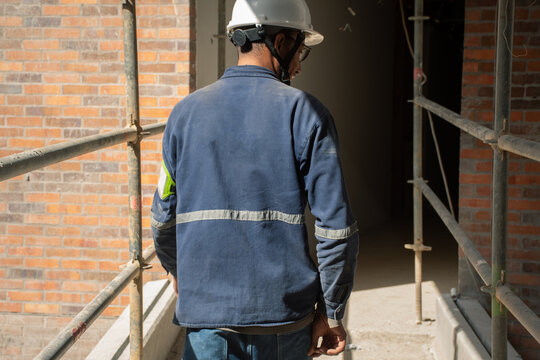 Construction worker inspecting site at a building under renovation