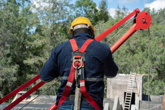 Construction worker operating equipment at outdoor site in daylight