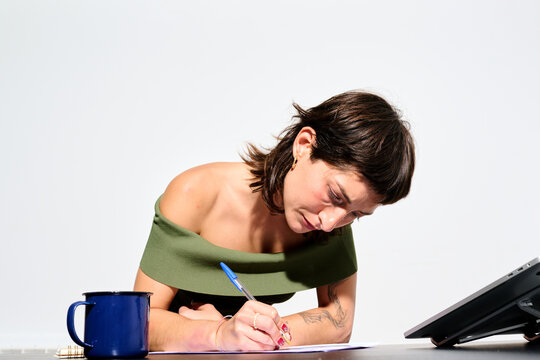 Focused intern Writing notes at work