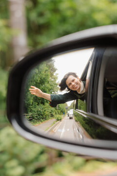 A woman looks out of a car window