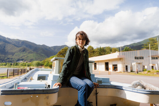 A woman sits on a boat