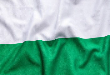 Obraz premium Texture of the Antioquia flag with soft lighting, a symbolic representation of the Antioquia region and its historical pride.