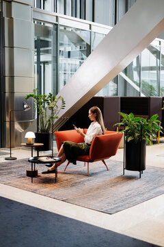 Woman Relaxing in Contemporary Business Lounge